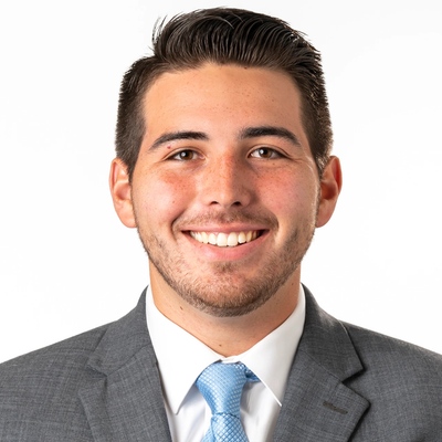 A man in a gray suit with a blue tie